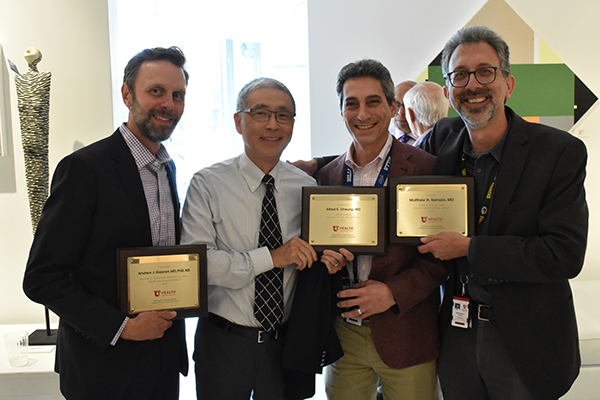 award winners with plaques